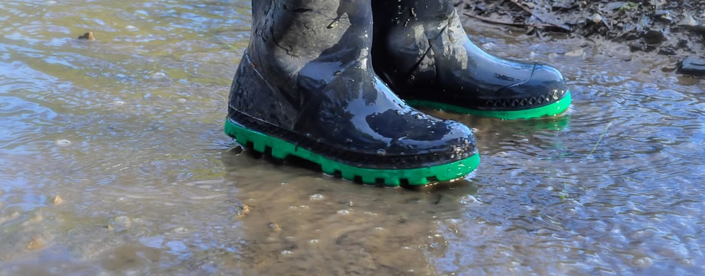 kids wellies in puddle